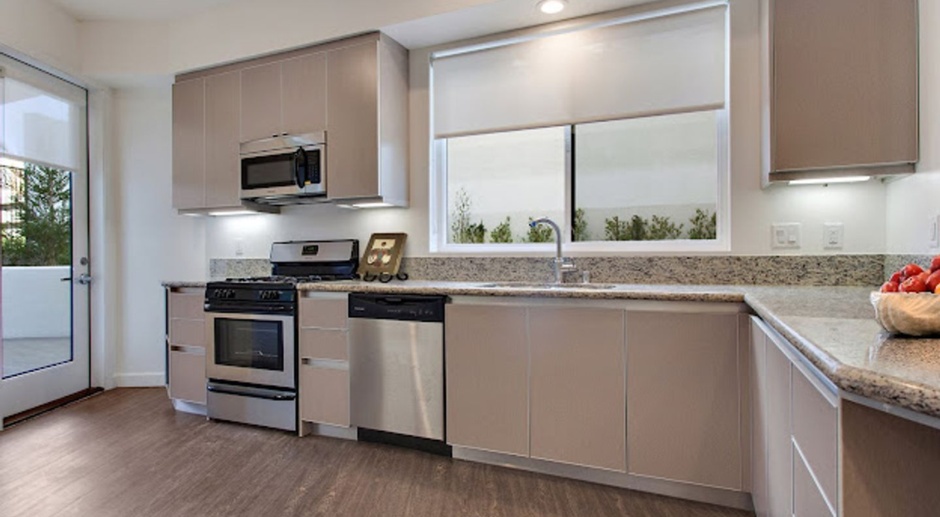 Penthouse Unit- Top Floor Unit includes: In-unit W/D, Two Kitchens, Private Balcony & More!